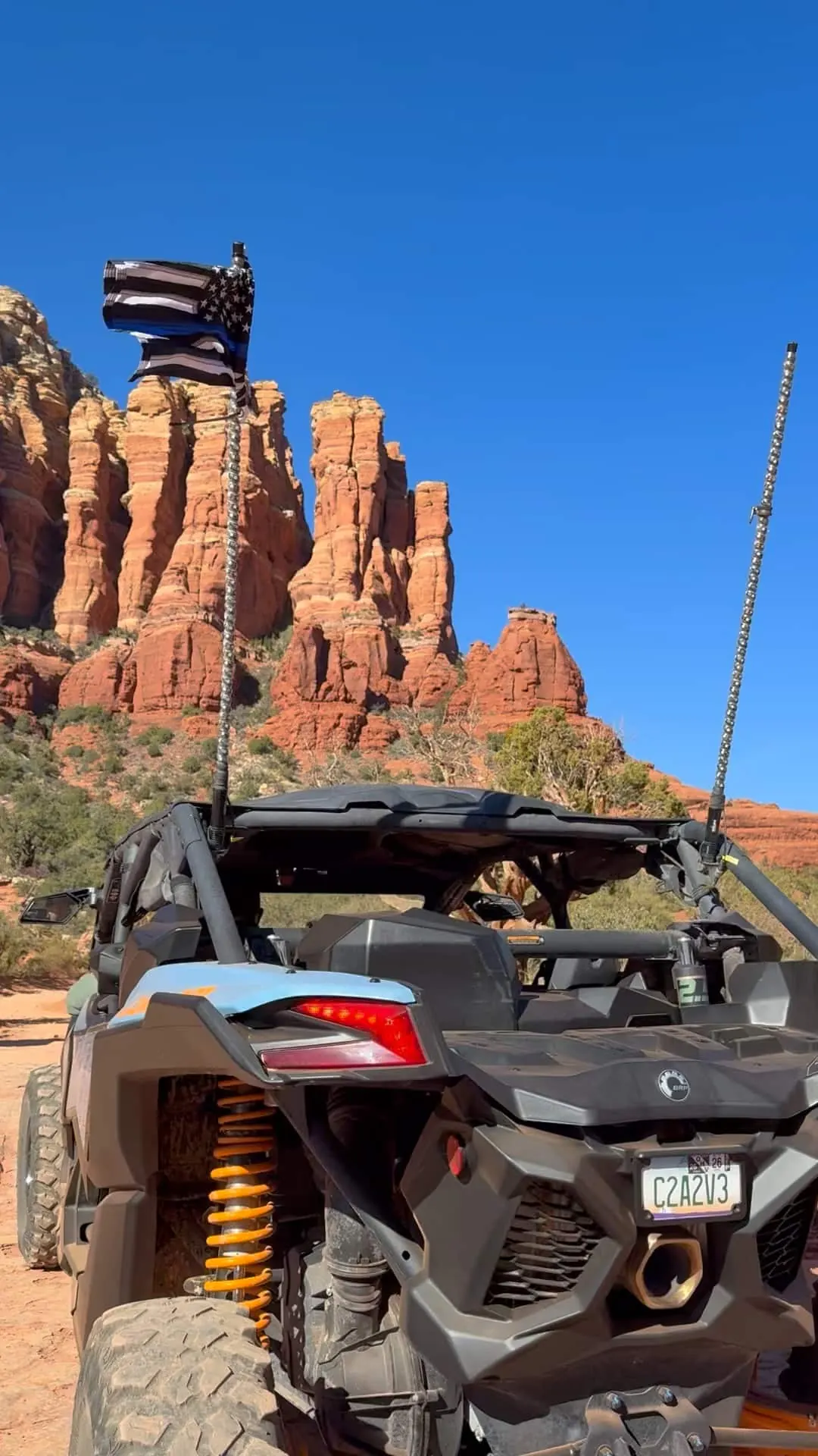 Close-up of Can-Am Maverick X3 suspension and wheel assembly on desert terrain