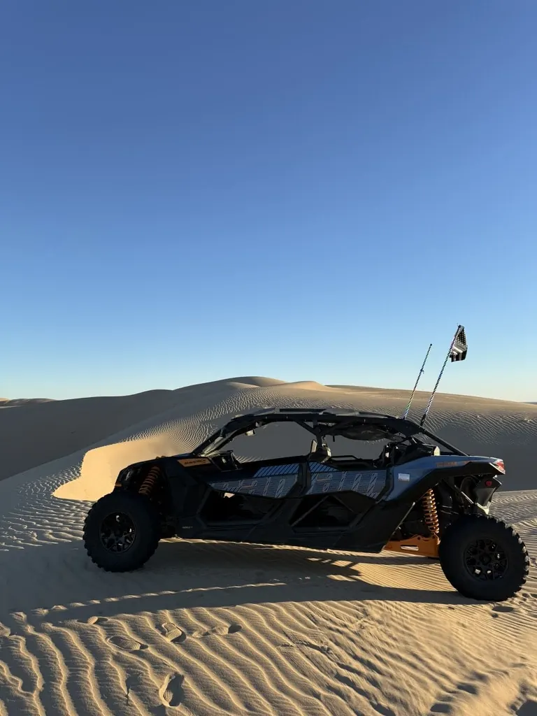 Can-Am Maverick X3 loaded on a trailer behind a pickup truck at the Apache Junction shop